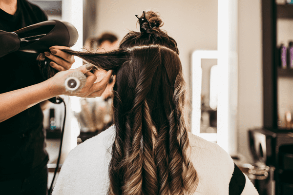 a woman getting her hair done in a salon